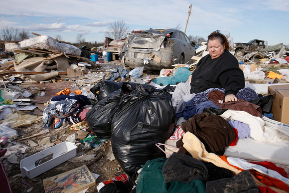 Chrys Michaels salvages what she can from the debris of homes where several people died in tornado destruction in East Bernstadt, Kentucky