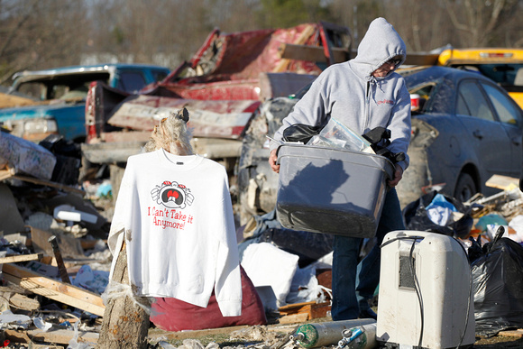 A shirt proclaiming "I can't take it anymore" hangs amid the debris of homes where several people died in tornado destruction in East Bernstadt, Kentucky