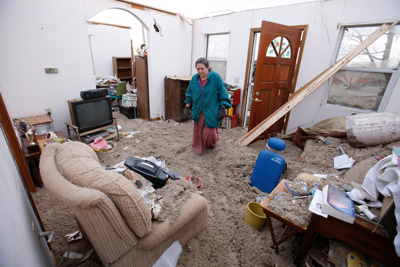 Carolyn Taulbee sifts through her belongings left from the tornado destruction in East Bernstadt, Kentucky
