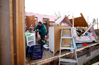 Carolyn Taulbee sifts through her belongings left from the tornado destruction in East Bernstadt, Kentucky