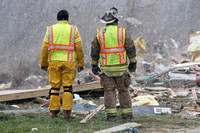 Snow falls as Laurel County Fire Dept Chief Tommy Johnston and Lt Trevor Allen perform a secondary survey of the tornado damage in East Bernstadt, Kentucky